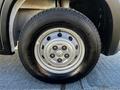 A close-up view of a silver wheel and tire from a 2021 RAM Promaster showing the rim design and tire tread pattern