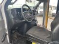 Interior view of a 2016 Chevrolet Express showing the driver's seat steering wheel and dashboard with controls and a central console