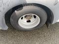 The wheel of a 2018 Chevrolet Express revealing a silver rim and black tire with visible tread pattern