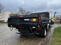 A 2021 Ford F-550 with a black flatbed in view, showcasing its rear and rear lights