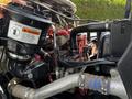 Engine components of a 2012 Freightliner M2 106 including air intake system and various hoses showing intricate details and connections