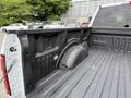 A 2018 Ford F-150 truck bed with a textured black liner and a rounded wheel well on the left side
