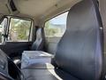 Interior view of a 2008 International 7500 truck showing two gray seats and a metal box between them