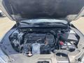 A 2017 Acura TLX engine compartment with visible engine components, battery, and various hoses and wires