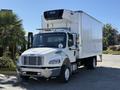 A 2017 Freightliner M2 106 truck with a white box trailer and a refrigeration unit on top parked with chrome mirrors and front grille