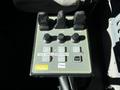 Control panel of a 2005 Volvo VND 122 featuring buttons for hoist enable main power and controls for granular lane and liquid functions