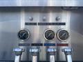 A control panel featuring gauges and switches labeled for panel lights compartment lights pump comp lights and tank suction and discharge