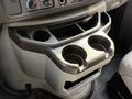 A gray console featuring two cup holders and storage compartments designed for a 2019 Ford Econoline