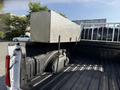 A 2021 Ford F-150 truck bed with a diamond-plate toolbox mounted at the front and bed liner texture visible on the sides and floor