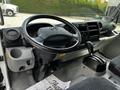 Interior of a 2018 Hino 195 showing the steering wheel gear shift and dashboard with controls