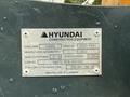 A silver identification plate on a 2022 Hyundai R55-9A excavator displaying model, serial number, manufacturing date, weight information, and attachment specifications