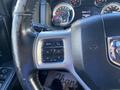 Steering wheel of a 2017 RAM 1500 featuring control buttons for audio and phone functions