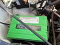 A green battery labeled MT-78 located in the engine compartment of a 2014 Chevrolet Express