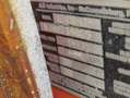 A metal identification plate for a 2009 JLG E300AJP with details such as model number and specifications