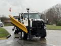 A 2016 Freightliner 108SD snowplow truck with a yellow plow blade attached at the front