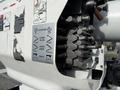 Close-up of a control panel on a 2011 International 4300 showing various operational instructions and hydraulic controls