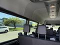 Interior view of a 2023 Mercedes-Benz Sprinter showing rows of black seats with adjustable headrests and overhead lights
