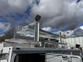 A 2024 Ford F-550 truck with a high-mounted light and a rack system on the roof designed for utility or industrial use