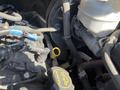 A 2016 Ford Transit engine compartment showing various hoses and components including an oil dipstick and coolant reservoir