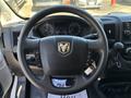 Steering wheel of a 2016 RAM Promaster with ergonomic controls and the RAM logo in the center