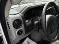 The interior dashboard of a 2017 Ford Econoline featuring the steering wheel air vents controls and instrument panel