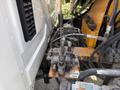 A hydraulic control valve mounted on a metal plate with labeled lever for operating an outrigger on a 2011 International 4300 truck