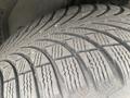 Close-up of the tire tread on a 2009 BMW X5 showcasing deep grooves and patterns for traction and grip on the road