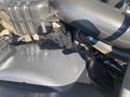 Close-up of the engine compartment of a 2014 Ford F-250 SD showing various components including hoses and a black plastic cover