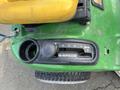A close-up of the gearshift and control panel of a 2021 John Deere L Series S lawn mower featuring a five-speed transmission dial