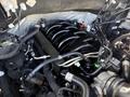 A 2018 Ford F-150 engine compartment featuring a black supercharger with various hoses and cables connected to it