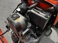 A 2015 Jacobsen Eclipse with a visible engine compartment featuring wires hoses and a fan assembly