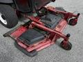 A red 2012 Toro Groundsmaster with a wide mowing deck and multiple wheels for maneuverability