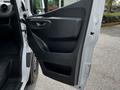 A closed door of a 2023 Mercedes-Benz Sprinter showcasing a black interior panel and handle