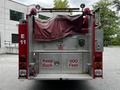 A 1991 Sutphen Deluge fire truck with a covered rear compartment and visible warning lights and signage indicating keep back 500 feet