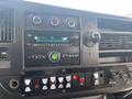 The dashboard of a 2017 Chevrolet Express featuring a radio display and various control buttons