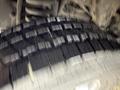 A close-up of a 2012 Ford Econoline tire showing tread patterns and details of the rubber surface