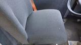 A gray fabric seat from a 2011 Ford Econoline with a simple design and visible stitching