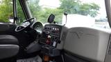 Interior view of a 2012 International 7400 truck showcasing the driver's seat dashboard control panel and various instrument controls