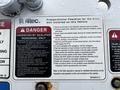 A close-up view of a warning label on a vehicle with safety instructions and a checklist for the Altec unit, including hazard symbols and guidelines for qualified personnel only