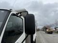 A 2014 Hino 195 truck with a side mirror visible in the foreground