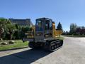 A 2022 TerraMac Tracked Dump with a yellow body and black tracks positioned on a concrete surface