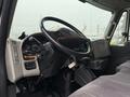 Interior view of a 2014 International TerraStar truck showing the steering wheel dashboard and gear shift with various control gauges and buttons