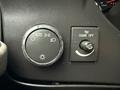 A dashboard control panel featuring a rotary knob for headlights with an auto setting and a switch for dome light control