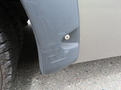 Close-up of the fender of a 2020 Chevrolet Express showing a scuffed area and a small plastic fastener