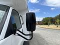 A side mirror of a 2020 Chevrolet Express mounted on a black arm