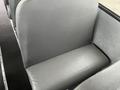 A single gray bus seat with a padded cushion and textured surface, part of the interior of a 2007 Freightliner B2