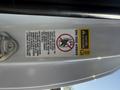 A warning label on the door of a 2015 Toyota Tacoma indicating safety information regarding the side airbags