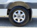 Close-up of a wheel on a 2023 Mercedes-Benz Sprinter featuring a silver alloy rim and a black tire with visible tread pattern