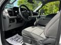 Interior of a 2024 Ford F-550 featuring gray fabric seats and a modern dashboard with controls and touchscreen display