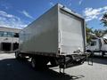 A 2021 Hino 338 truck with a large, smooth rear cargo area and a roll-up door at the back